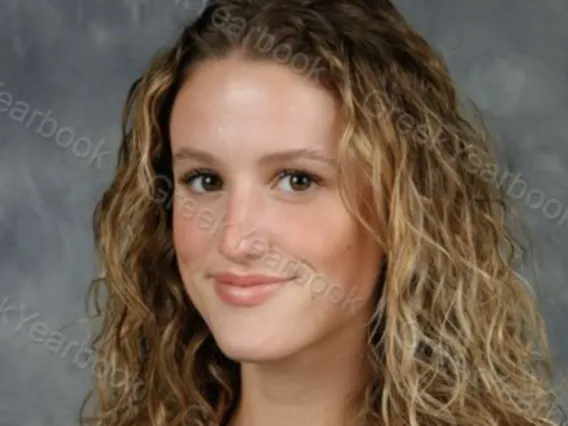 headshot of a person with a grey background