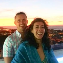 Couple smiling with city lights in the background